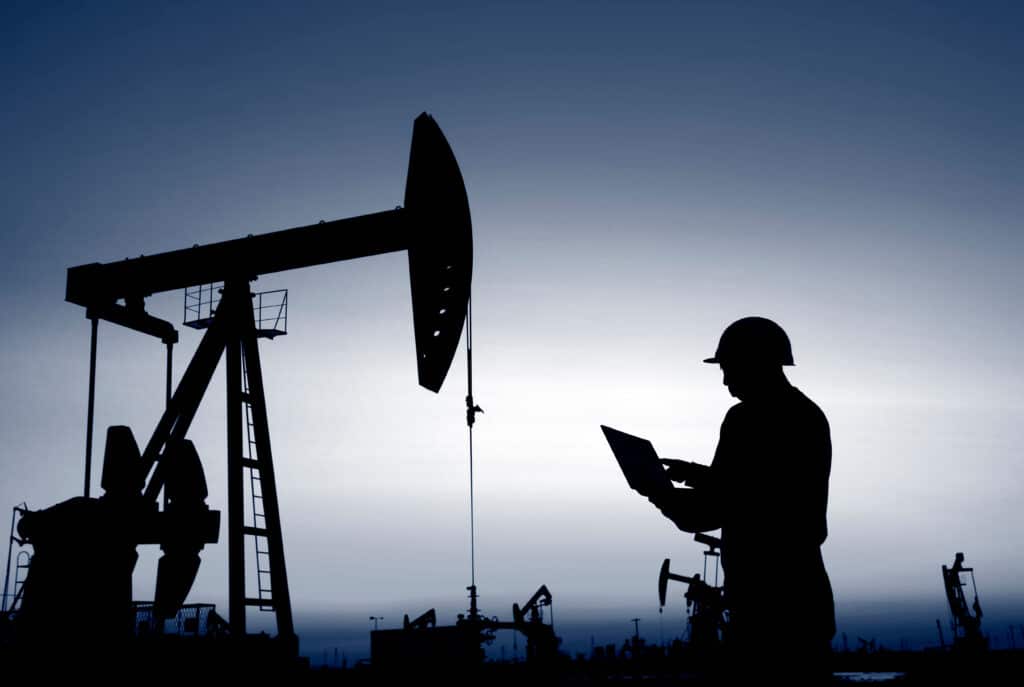 Oil field workers using rigs ensuring safety by using their hse manual for oil and gas industry.