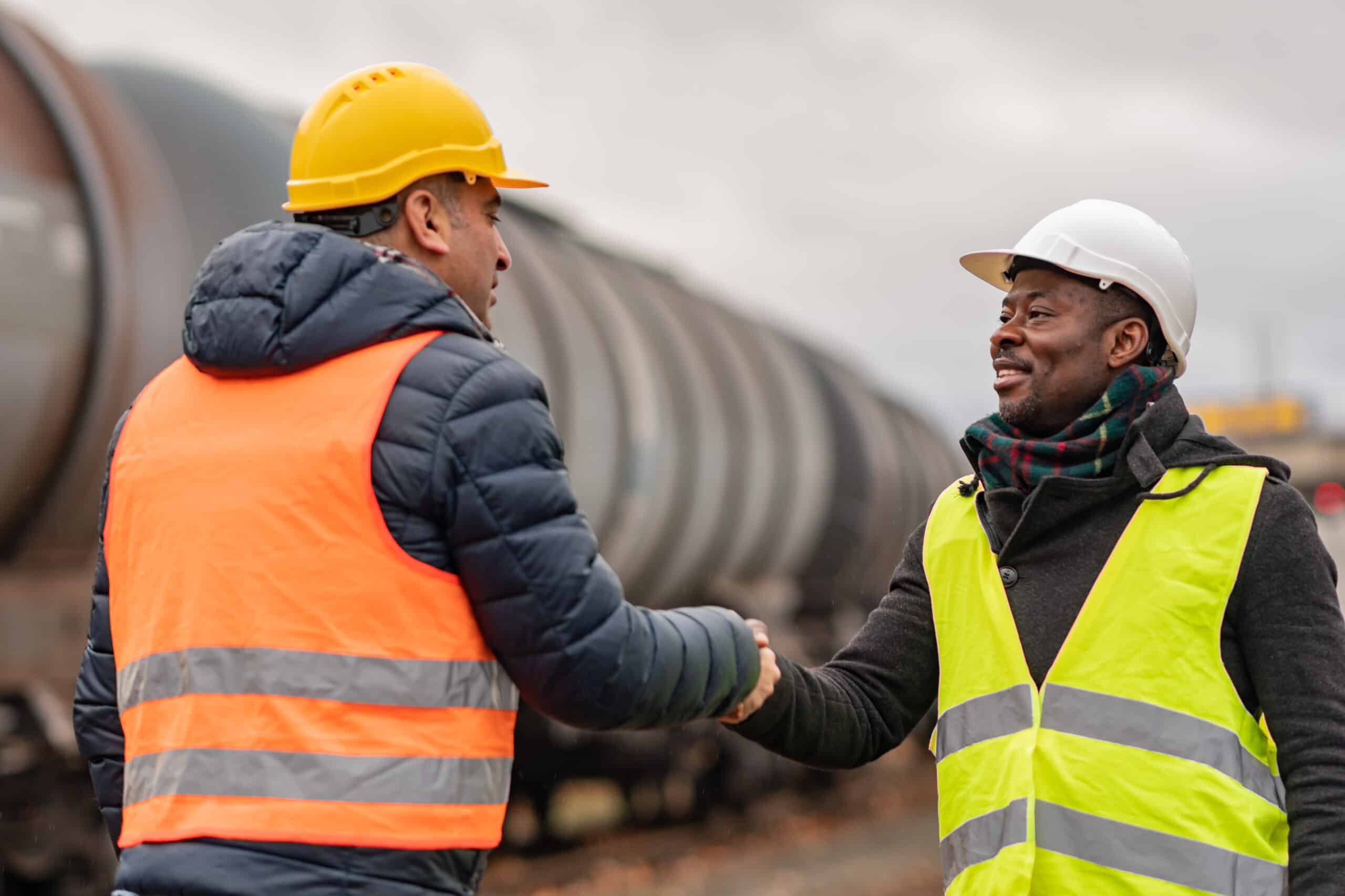 Engineers reaching an agreement on a construction site after becoming Avetta certified.